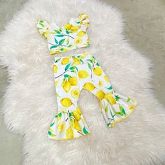 "Beautiful lemons bell pants and crop top. Perfect for lemonade themed birthdays.  The set is made of cotton lycra stretchy knit fabric. Runs true to size. I won't recommend sizing up.  Size-inseam of leggings/waist  NB-6\"/13\" 0-3m-7\"/14.5\" 3-6m-8\"/15.5\" 6-9m- 9\"/16\" 9-12m-10.5\"/16.5\" 12-18m-11.5\"/17.25\" 18-24m-13\"/18\" 2-3t-14.5\"/18.5 3-4t-15\"/19\" 4-5y-15.5\"/19.5\" 5-6y-16\"/20\"" Spring Fun Fitted Sets, Playful Yellow Fitted Sets, Fitted Yellow Playful Sets, Playful Fitted Yellow Sets, Cute Fitted Yellow Bottoms, Bell Pants, Lemonade Stand, Girls Clothing Sets, Themed Outfits