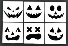 four square coasters decorated with halloween faces and pumpkin noses, all in black and white