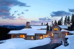 a house is covered in snow at dusk