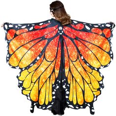 a woman wearing a butterfly wings costume with her hands on her hips and the wings open