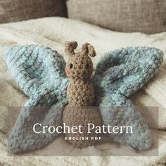 a crocheted stuffed animal sitting on top of a bed with the words crochet pattern english pop