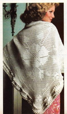 a woman wearing a white crocheted shawl