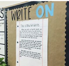 a bulletin board with writing on it and plants in the back ground next to it