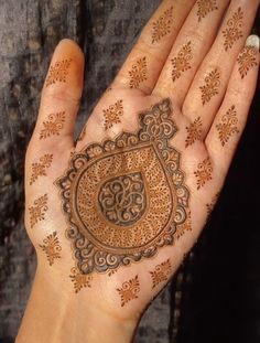 a woman's hand with henna on it