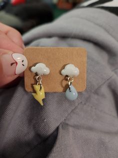 Spring is in the air, and so is the rain. Celebrate spring or just a good thunderstorm with these cute storm cloud earrings. Handmade from polymer clay and resin with sterling silver posts Studded Clay Earrings, Cute Fun Earrings, Polymer Clay Stud Earrings Ideas, Polymer Clay Earring Studs, Polymer Clay Cloud, Stud Clay Earrings, Cloud Earrings, Polymer Clay And Resin, Spring Showers