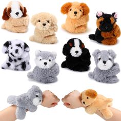 a hand is holding several small stuffed animals