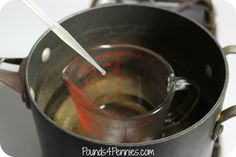 a metal pot filled with liquid on top of a stove