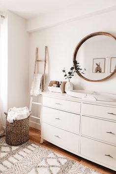 a white dresser sitting in a bedroom next to a window with an instagram sign above it