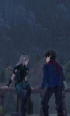 two people sitting on a bench in the rain