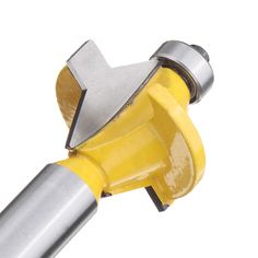 a close up of a yellow and silver tool