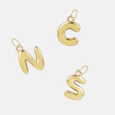 Bubble Letter Charms A playful addition to your necklace or bracelet, our 14K Solid Gold Bubble Letter jewelry charms create a sense of lighthearted nostalgia. Their rounded, soft shape add a whimsical feel to any charm collection. Custom letter jewelry is perfect for layering and unique personalization with a timeless appeal. Our loose charms ship with a large jumpring that will allow it to slip over the clasp of our Dainty Chain (used for our Classic Silhouette Necklaces) for easy at home assembly. If you are adding on to an existing VCS piece and wish to make sure everything matches, please refer to our Add-A-Charm product. Product Details Available in 14k Solid Yellow, White and Rose Gold Approximate Size: 10 x 7.75 mm charm Additional Details These are made to order, so please allow u 14k Yellow Gold Initial Necklace With Charms, Customizable Yellow Gold Initial Pendant Charm Necklaces, Customizable Yellow Gold Initial Pendant Charm Necklace, Personalized Yellow Gold Charms For Everyday, 14k Yellow Gold Initial Pendant Charm, Yellow Gold 14k Initial Pendant Charms, Personalized Yellow Gold Charms With Initial Pendant, Silhouette Jewelry, Locket Earrings