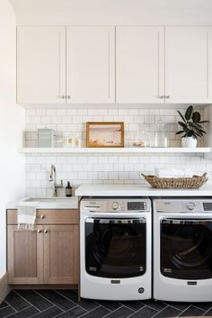 a washer and dryer sitting in a kitchen next to each other on top of a counter