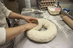 a doughnut being made in a kitchen