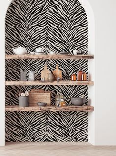 a zebra print wallpaper in a room with shelves full of books and knickknacks