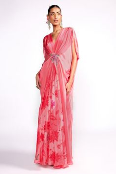 Flamingo pink draped kaftan with floral print, highlighted with floral embroidery on the waistband.
Components: 1
Pattern: Print, Embroidery
Type Of Work: Floral
Neckline: V Neck
Sleeve Type: Split Sleeves
Fabric: Crepe, Lining: Crepe
Color: Pink
Other Details: 

Model height: 5ft 8 inches, wearing size S
Note: Hair accessory worn by the model is not for sale
Occasion: Resort - Aza Fashions Pink Traditional Drape Dress For Spring, Pink Spring Dress With Traditional Drape, Traditional Pink Dress For Spring, Pink Saree Dress For Spring, Festive Pink Kaftan For Reception, Pink Dresses With Kimono Sleeves For Wedding, Pink Kaftan For Spring Evening, Pink Evening Kaftan For Spring, Floral Embroidered Kaftan For Party