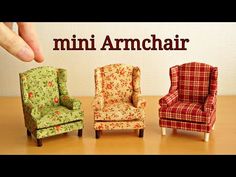 three miniature chairs sitting next to each other on a wooden table with the words mini armchair above them