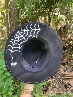 "Look spooktacular this season with our Spider Nights handpainted hat! Perfect to wear casually or for a fun occasion.  THIS IS A LARGER HAT INSIDE,  Head width is 8\" x 6\" Just a heads up😉 Made of vegan suede. Dimensions: 14\" wide x 15.5\" long. 3.5 inch brim Adjustable strap inside inner band for the better fit." Halloween Witchy Hat With Wide Brim, Halloween Witchy Wide Brim Hat, Witchy Black Costume Hats And Headpieces For Fall, Witchy Black Costume Hat For Fall, Witchy Wide Brim Hat For Fall, Witchy Costume Hats With Curved Brim For Fall, Black Fedora Halloween Costume Hat, Witchy Adjustable Costume Hats For Fall, Handmade Witchy Costume Hats And Headpieces