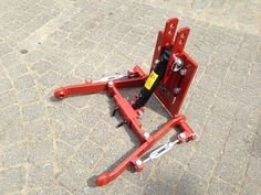 a pair of red jacks sitting on the ground next to a brick floor with a yellow tag