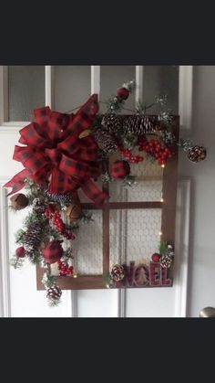 a christmas wreath hanging on the front door