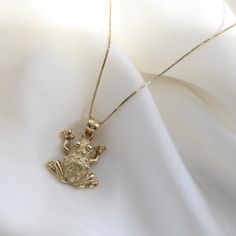 "14k Gold Frog Necklace Charm, Animal lovers Jewelry, 14K Gold 2-D Frog Necklace, Yellow Gold Frog Necklace Charm, Animal Lovers Gift, Can be worn with other necklaces, great for layers. A Perfect 14K Gold gift. . . . * Pendants Measurements With Bail: ((20 x 16 mm) * Chain is included ( 1MM Box Chain) * Stamp: Real 14k Gold * Never gold filled or plated * Hypoallergenic * Water Resistant * Scratch Resistant * Packaged With Free Gift Box . . . If you have any questions, just hit the \"Message the Seller\" button ( bottom right of the page) and we will get back to you within a few hours. . . .  IF YOU WISH TO BUY THE PENDANT ALONE, COPY AND PASTE THE LINK BELOW IN A NEW TAB TO FIND THAT LISTING https://www.etsy.com/listing/1235840487/14k-gold-turtle-necklace-charm-sea? . . . Mailed in a cut Tiana Necklace, The Princess And The Frog Jewelry, Gold Frog Necklace, Frog Pendant, Cat Necklace Gold, Frog Necklace, Turtle Necklace, Gold Gift, Game Dresses