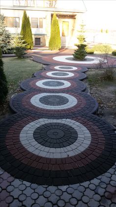 a walkway made out of bricks with circles painted on it