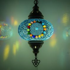 a blue glass lamp hanging from a ceiling