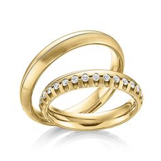 two yellow gold wedding rings with diamonds on each one and the other in between them