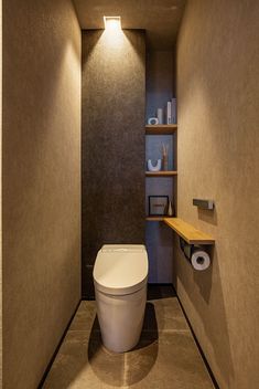 a bathroom with a toilet and shelves on the wall next to it's walls