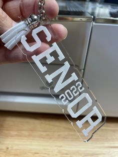 Give your graduate the keys to success!! Large 2022 personalized graduation key chain.  Two options available Name or Senior. Wood engraved or acrylic engraved color options are clear, mirrored rose gold or mirrored silver Measures 4 1/2X1 1/4.  These can be used as zipper pulls on gym bags, book bags, purses, coats or to just hang on car mirror. To get back to my shop click below 👇🏻  https://homeandsparrowshop.etsy.com LETS GET SOCIAL! Follow me on Instagram @homeandsparrow Cheap Personalized Graduation Accessories, Graduation Keychain, Keys To Success, Book Bags, Gym Bags, Zipper Pulls, Car Mirror, Silver Mirrors, Bags Purses