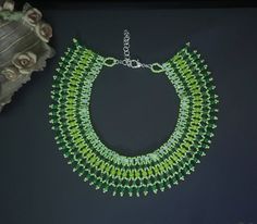 This beautiful, handmade green beaded necklace is the perfect accessory for any outfit. The beads are all different shades of green, making it a truly eye-catching piece. It's also lightweight and comfortable to wear, so you can enjoy it all day long. The beads are strung together with care, and the necklace is adjustable to ensure a comfortable and customized fit. Whether you're dressing up for a special occasion or just adding a pop of color to your everyday look, this necklace is a must-have! Green Beaded Bracelet For Gift, Green Beaded Chain Bracelet As Gift, Green Beaded Chain Bracelets As A Gift, Green Beaded Chain Jewelry, Green Beaded Bracelet With Round Beads, Green Beaded Bracelets With Round Beads, Handmade Green Bohemian Beaded Necklaces, Elegant Green Beaded Necklaces With Polished Beads, Elegant Green Beaded Necklace With Round Beads