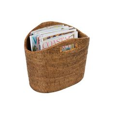 a wicker basket with magazines in it on a white background for use as a storage container