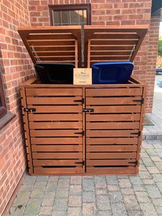 a wooden storage unit with two bins on top