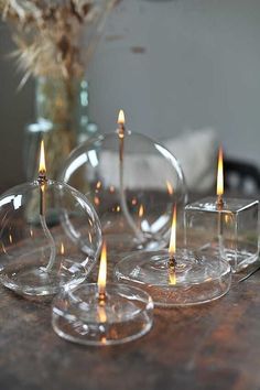 three clear candles sitting on top of a table