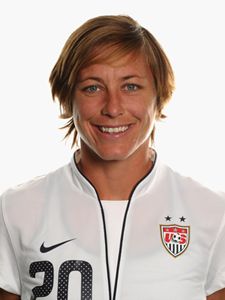 a female soccer player is posing for a photo