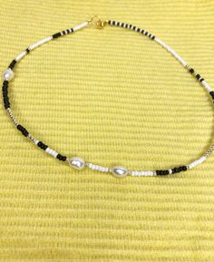 "Black and white Beaded choker necklace is handmade from the best materials. You can buy it as a gift for a friend, sister, mother. BEADS SIZE : The pearls are 6-8mm (0.23 - 0.31 inch), and the beads are 2-3mm (0.07 - 0.11 inch). MEASUREMENTS: Choose a length for your choker necklaces (measured in inches). Measure the length of your neck with a measuring tape or you can use any thread, rope, or cable for telephone and after apply the measurements to a regular ruler. If you have any questions abo Trendy White Pearl Choker Necklace, Trendy White Single Strand Beaded Necklace, White Pearl Necklace With Colorful Beads As Gift, White Beaded Necklaces With Black Beads As Gift, White Beaded Necklaces With Black Beads For Gifts, Trendy White Pearl Chain Beaded Necklaces, Trendy White Pearl Chain Beaded Necklace, White Jewelry With Black Beads As Gift, Minimalist White Pearl Chain Beaded Necklace