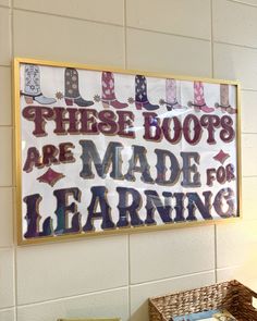 there is a sign that says these boots are made for learning on the wall in this classroom