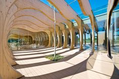 the inside of a building with curved wooden walls