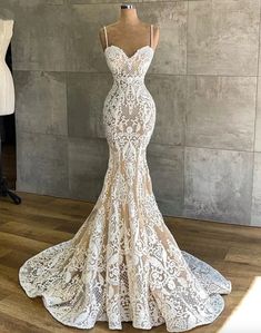 a wedding dress on display in front of a mannequin