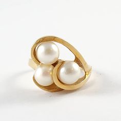 Vintage 14k Solid Yellow Gold & Round Pearl Cocktail Ring. This ring is a size 6.5. It is marked 14k with a symbol and weighs about 5.7 grams. It is in good condition with some light wear and scratches. Add this piece to your collection today! Visit our FAQ section: https://www.etsy.com/shop/KayZees?ref=hdr_shop_menu#more-section If you have any questions please don't hesitate to ask! 14k Gold Hallmarked Pearl Ring, 14k Gold Pearl Ring With Polished Finish For Anniversary, 14k Gold Polished Pearl Ring For Anniversary, Timeless 14k Gold Pearl Ring Hallmarked, 14k Gold Hallmarked Pearl Ring For Anniversary, Classic 14k Gold Bypass Ring As Gift, 14k Gold Pearl Ring Stamped 14k, 14k Gold Bypass Ring For Formal Occasions, Elegant Wedding Ring With Hallmark