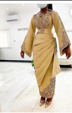 This elegant African Brides outfit is specially designed to make you look unique among others in all occasion. our cloths are made with quality fabric, great sewing, neat finishing and the price is affordable. The cloths are of different colors you can choose any color of your choice. Please contact us to make you look unique in all event. Luxury Brocade Wedding Dresses, Elegant Beige Sets With Intricate Embroidery, Elegant Brocade Party Gown, Elegant Gold Silk Sets, Elegant Floor-length Brocade Gown, Elegant Embroidered Gown With Traditional Drape, Elegant Brocade Dresses For Wedding, Elegant Festive Gown For Ceremonies, Elegant Ball Gown For Ceremony