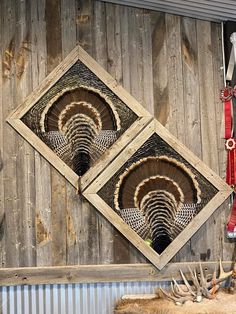 two square shaped mirrors hanging on the side of a wooden wall next to antlers