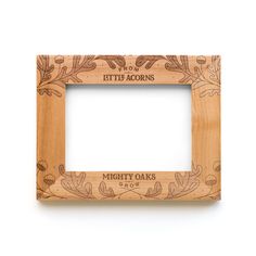 a wooden frame with the words mighty oaks engraved on it, in front of a white background