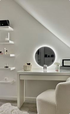 a white desk with a mirror on top of it next to a chair and shelves