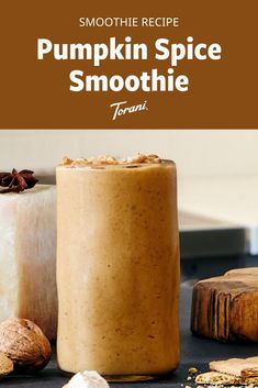 pumpkin spice smoothie in a mason jar on a counter with cinnamons and other ingredients