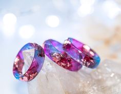 A beautiful blue and Fuschia faceted resin ring with pink metallic flakes inside. Both blue and Fuschia tone resins are beautifully mixed to create this pretty and elegant ring. This resin ring is perfect for stacking! It's faceted all the way around and it is so comfortable to wear. All my resin rings are handmade with self-made molds. they are also hand-sanded and polished, to be smooth and comfortable to wear. Given the nature of the resin, my rings may contain tiny bubbles and imperfections, Pink Resin Ring Jewelry, Unique Resin Crystal Ring Gift, Adjustable Pink Resin Rings, Handmade Resin Rings As A Gift, Unique Resin Rings For Gifts, Handmade Pink Resin Rings, Purple Round Resin Jewelry, Handmade Resin Jewelry For Weddings, Unique Pink Promise Ring Jewelry