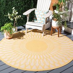 a yellow and white rug sitting on top of a wooden floor next to a chair