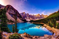 a mountain lake surrounded by trees and mountains