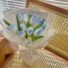 a bouquet of blue and white tulips on a table