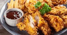 fried chicken and french fries on a plate with ketchup