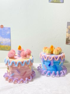 two cakes sitting on top of a table next to each other